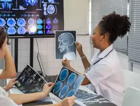 Radiologic technologist looking at x-ray