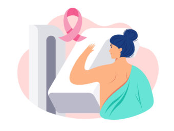 woman standing by a mammogram machine